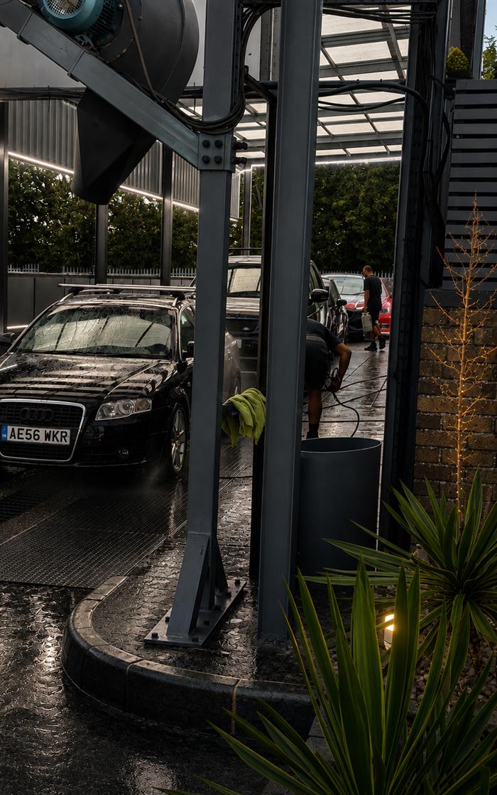An Audi being rinsed down in the covered wash bay